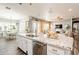 Kitchen island with granite countertops and white cabinets at 28821 N Ashbrook Ln, Queen Creek, AZ 85144