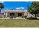 Home's backyard features a covered patio and grassy area at 303 W 9Th St, Mesa, AZ 85201