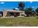 View of the home's backyard with a patio and lush lawn at 303 W 9Th St, Mesa, AZ 85201