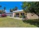 Landscaped backyard with a covered patio and grassy yard at 303 W 9Th St, Mesa, AZ 85201