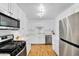 Modern kitchen with stainless steel appliances and hardwood floors at 303 W 9Th St, Mesa, AZ 85201