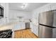 Updated kitchen, featuring white cabinetry and stainless steel appliances at 303 W 9Th St, Mesa, AZ 85201