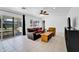 Living Room with sliding glass doors to backyard, brown leather couch, and yellow armchair at 303 W 9Th St, Mesa, AZ 85201