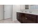 Double vanity bathroom with dark brown cabinets at 30905 W Fairmount Ave, Buckeye, AZ 85396