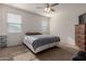 Bright bedroom with a queen-size bed and ceiling fan at 30905 W Fairmount Ave, Buckeye, AZ 85396