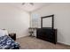 Bedroom with dresser, keyboard, and floral bedding at 30905 W Fairmount Ave, Buckeye, AZ 85396