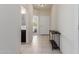 Bright and airy entryway with tile flooring and a modern console table at 30905 W Fairmount Ave, Buckeye, AZ 85396