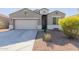 Curb appeal abounds in this charming one-story home, featuring a well-manicured front yard at 30905 W Fairmount Ave, Buckeye, AZ 85396