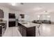 Open kitchen with an island and seating, looking toward the living room at 30905 W Fairmount Ave, Buckeye, AZ 85396