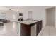 Kitchen island with granite countertop, sink, and dishwasher at 30905 W Fairmount Ave, Buckeye, AZ 85396