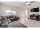 Open concept living room features a cozy sectional sofa and plenty of natural light at 30905 W Fairmount Ave, Buckeye, AZ 85396