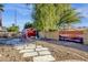 Backyard with shed, stone pathway, and painted wall at 3101 W Topeka Dr, Phoenix, AZ 85027