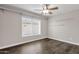 Bedroom with ceiling fan, large window, and wood flooring at 3101 W Topeka Dr, Phoenix, AZ 85027