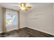 Bedroom with ceiling fan, window, and wood flooring at 3101 W Topeka Dr, Phoenix, AZ 85027