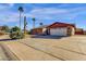 House with a tan garage door and a cacti in front at 3101 W Topeka Dr, Phoenix, AZ 85027