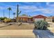 Charming brick home with a large saguaro cactus in the front yard at 3101 W Topeka Dr, Phoenix, AZ 85027