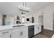 Modern kitchen with island, white cabinets and stainless steel appliances at 3101 W Topeka Dr, Phoenix, AZ 85027