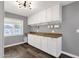 Laundry room with shaker cabinets and brown countertop at 3101 W Topeka Dr, Phoenix, AZ 85027