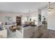 Open living room featuring hardwood floors, a cozy seating area, and adjacent dining space at 3101 W Topeka Dr, Phoenix, AZ 85027