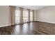 Living room with large windows, neutral walls, and vinyl flooring at 3101 W Topeka Dr, Phoenix, AZ 85027