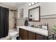 Modern bathroom with dark vanity, updated fixtures, and a shower/tub combo at 3141 S 83Rd Cir, Mesa, AZ 85212