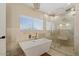 Spa-like bathroom featuring a soaking tub and glass shower at 3141 S 83Rd Cir, Mesa, AZ 85212