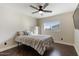 Cozy bedroom with a striped bedspread and dark wood floors at 3141 S 83Rd Cir, Mesa, AZ 85212