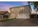 Two-story house with tan exterior, white garage door, and small front yard at 3141 S 83Rd Cir, Mesa, AZ 85212