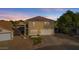 Two-story house with tan exterior, white garage door, and small front yard at 3141 S 83Rd Cir, Mesa, AZ 85212