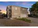 Two story house with tan exterior, white garage door, and landscaped yard at 3141 S 83Rd Cir, Mesa, AZ 85212