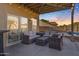 Covered patio with wicker furniture, perfect for outdoor relaxation at 3141 S 83Rd Cir, Mesa, AZ 85212