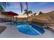 Stunning kidney-shaped pool with a waterfall feature and patio seating at 3141 S 83Rd Cir, Mesa, AZ 85212