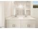 Bright bathroom featuring double sinks, white cabinetry, and a glass-enclosed shower at 3201 E Hayden Rose Ave, San Tan Valley, AZ 85143