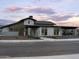 Striking exterior view of community clubhouse at dusk, showcasing modern architecture at 3201 E Hayden Rose Ave, San Tan Valley, AZ 85143