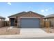 Charming single-story home featuring a two-car garage and low-maintenance desert landscaping at 3201 E Hayden Rose Ave, San Tan Valley, AZ 85143