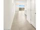 Bright hallway featuring tile flooring and sliding glass doors to the backyard at 3201 E Hayden Rose Ave, San Tan Valley, AZ 85143