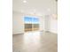 Bright living room featuring tile flooring, modern lighting, and sliding door to backyard at 3201 E Hayden Rose Ave, San Tan Valley, AZ 85143