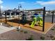 A high angle view of the community playground with slides, shade, and nearby pool and community center at 3201 E Hayden Rose Ave, San Tan Valley, AZ 85143