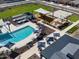 Aerial view of a community pool with lounge chairs, shade, and nearby playground and basketball court at 3201 E Hayden Rose Ave, San Tan Valley, AZ 85143