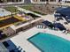 Aerial view of a swimming pool with lounge chairs, picnic tables and shade umbrellas near a playground at 3201 E Hayden Rose Ave, San Tan Valley, AZ 85143