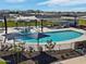 A high angle view of the community pool with lounge chairs and splashpad feature in a new construction neighborhood at 3201 E Hayden Rose Ave, San Tan Valley, AZ 85143