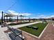 Community recreation area with benches, picnic tables, and cornhole game, landscaped with artificial turf at 3201 E Hayden Rose Ave, San Tan Valley, AZ 85143