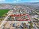 Aerial view of property with surrounding buildings and fields at 3204 W Mcneil St, Laveen, AZ 85339