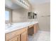 Double vanity bathroom with updated light fixtures and tile flooring at 3482 W Mineral Butte Dr, San Tan Valley, AZ 85144