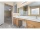 Double vanity bathroom with wood cabinets and tile flooring at 3482 W Mineral Butte Dr, San Tan Valley, AZ 85144