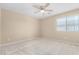 Well-lit bedroom with carpeted floor and ceiling fan at 3482 W Mineral Butte Dr, San Tan Valley, AZ 85144