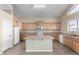 Kitchen with island, wood cabinets, and stainless steel appliances at 3482 W Mineral Butte Dr, San Tan Valley, AZ 85144