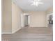 Spacious living room featuring light neutral walls and laminate flooring at 3482 W Mineral Butte Dr, San Tan Valley, AZ 85144