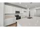 Modern kitchen with white cabinets and stainless steel appliances at 37535 W Patterson St, Maricopa, AZ 85138