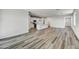 Open living room with vinyl plank flooring and kitchen view at 37535 W Patterson St, Maricopa, AZ 85138